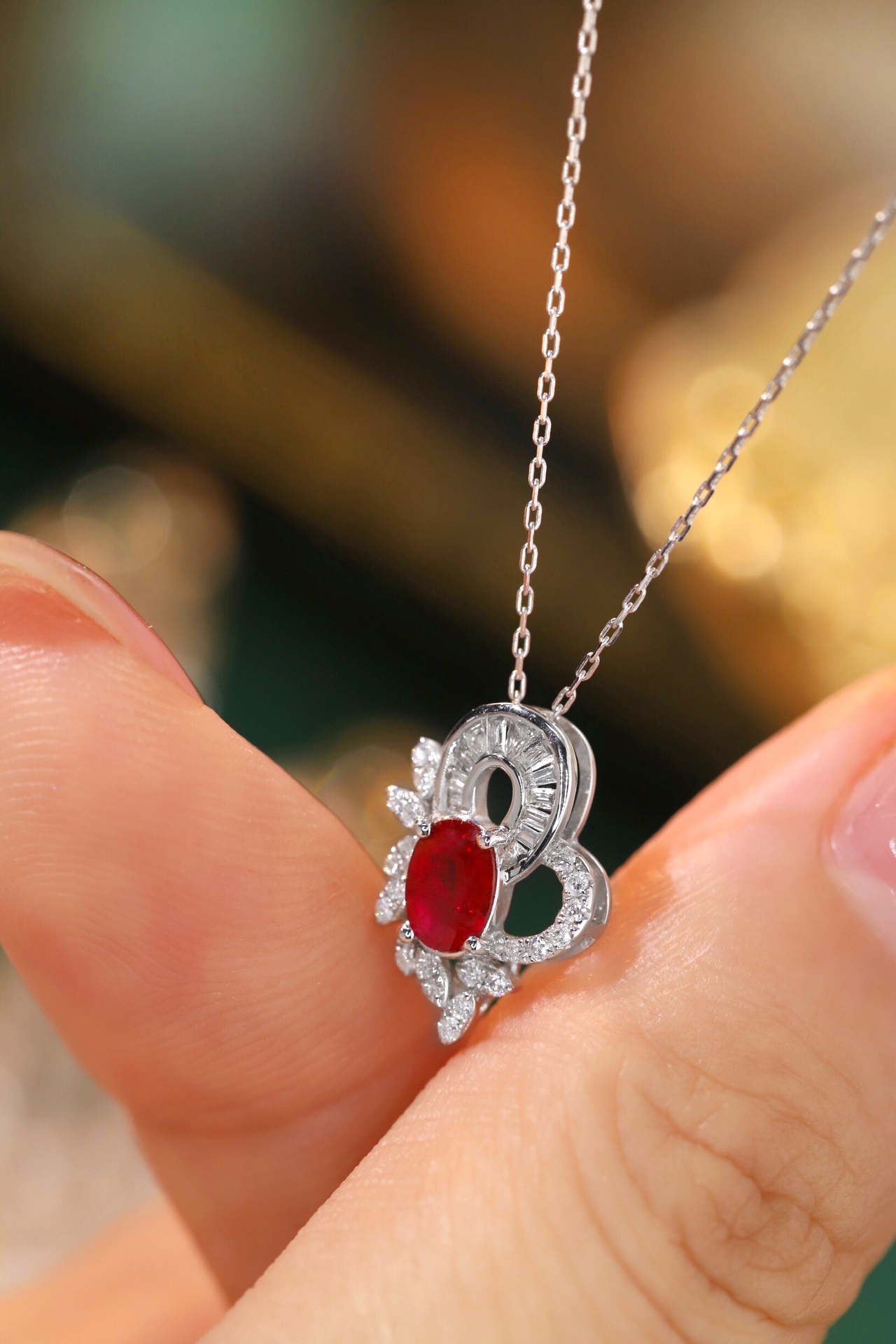 18K gold necklace  necklace is adorned with a 0.55-carat natural ruby and a 0.30-carat natural diamond; both stones are secured in place using a four-prong setting. The ruby has an oval shape, while the diamond is of a squ