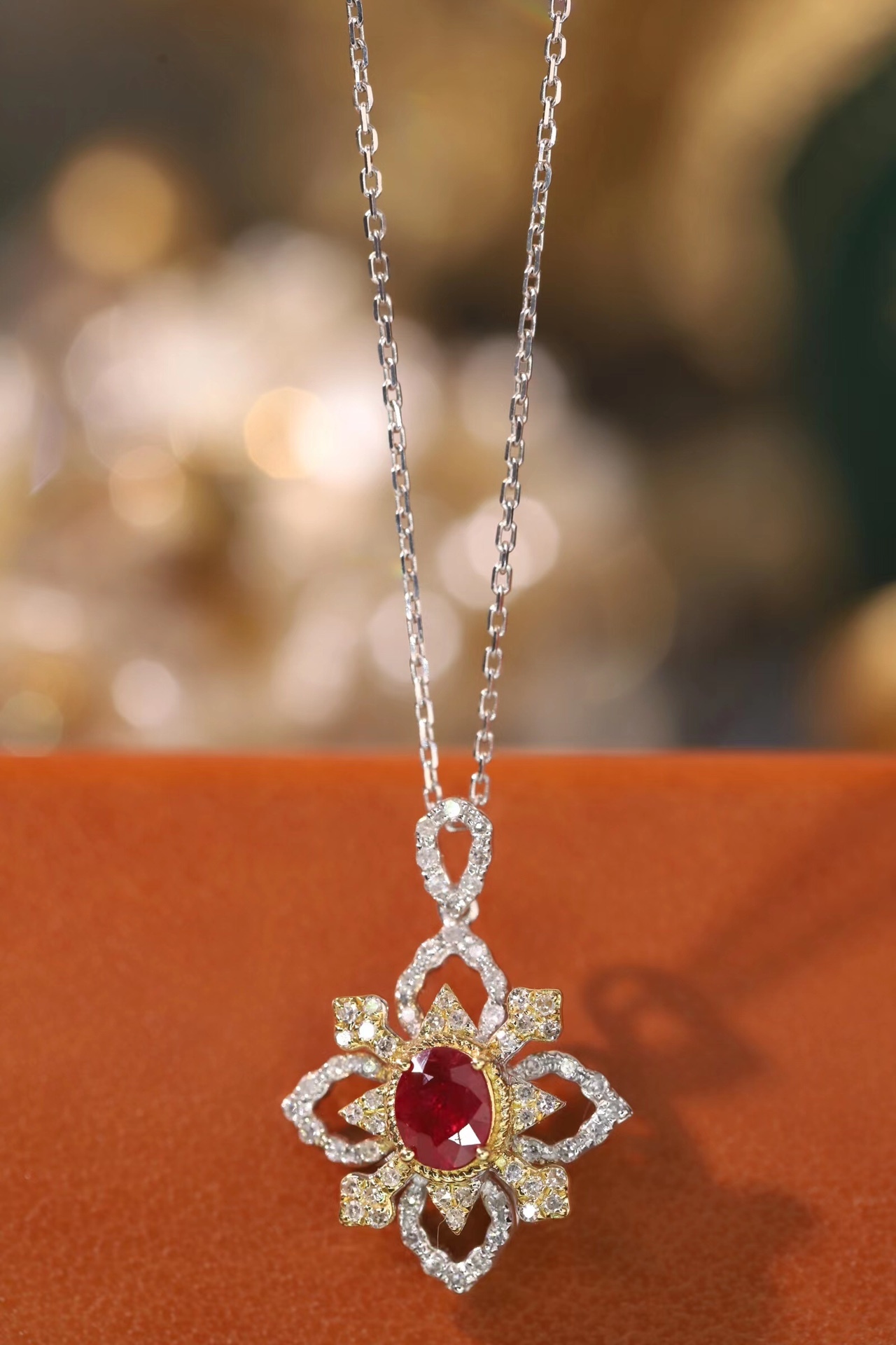 18k gold necklace set with an oval ruby of 0.38 carats, as well as additional stones of 0.22 carats each.