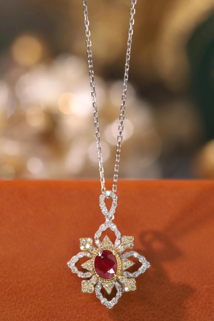 18k gold necklace set with an oval ruby of 0.38 carats, as well as additional stones of 0.22 carats each.