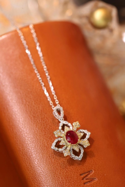 18k gold necklace set with an oval ruby of 0.38 carats, as well as additional stones of 0.22 carats each.