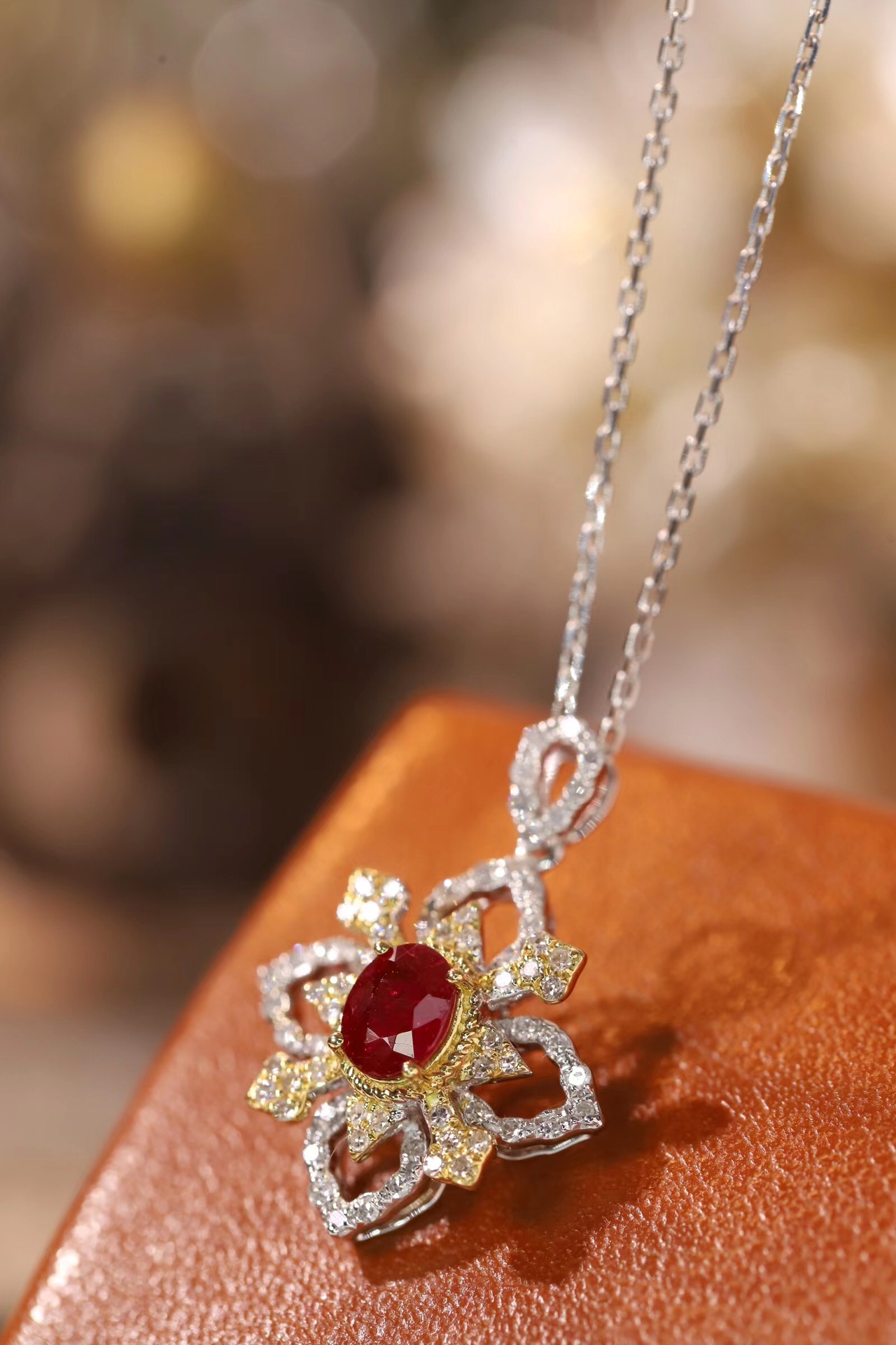 18k gold necklace set with an oval ruby of 0.38 carats, as well as additional stones of 0.22 carats each.