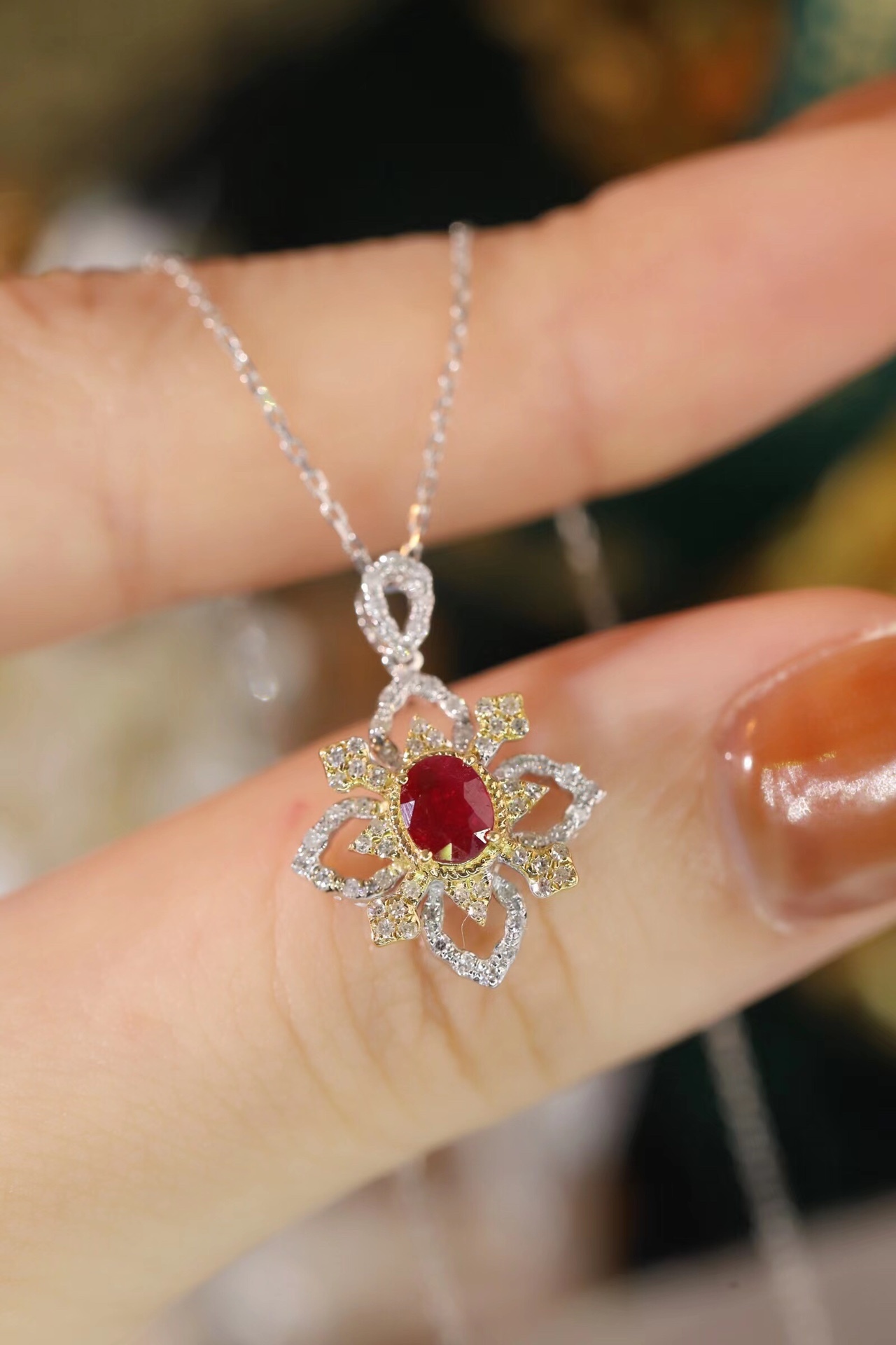 18k gold necklace set with an oval ruby of 0.38 carats, as well as additional stones of 0.22 carats each.