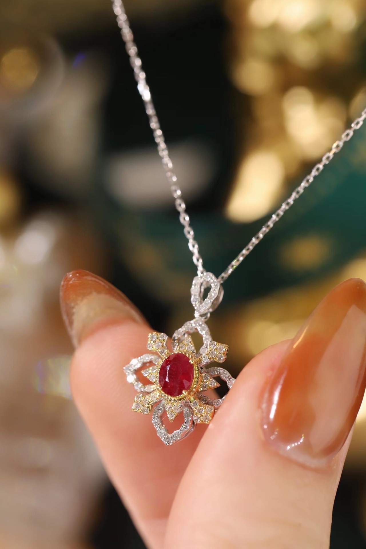 18k gold necklace set with an oval ruby of 0.38 carats, as well as additional stones of 0.22 carats each.