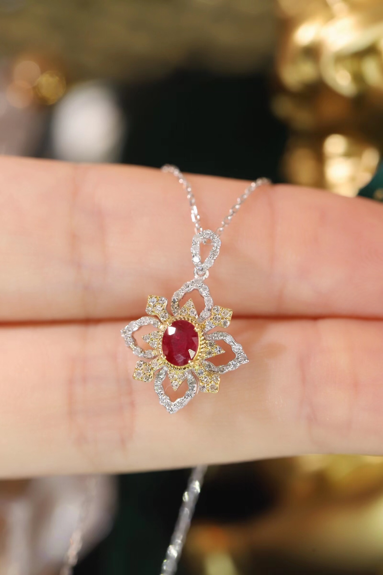 18k gold necklace set with an oval ruby of 0.38 carats, as well as additional stones of 0.22 carats each.