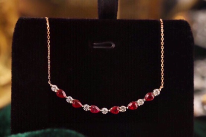18-karat gold necklace set with 1.15-carat ruby and 0.38-carat diamond.