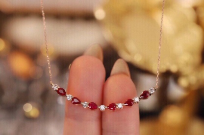 18-karat gold necklace set with 1.15-carat ruby and 0.38-carat diamond.