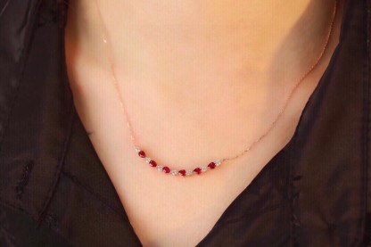 18-karat gold necklace set with 1.15-carat ruby and 0.38-carat diamond.