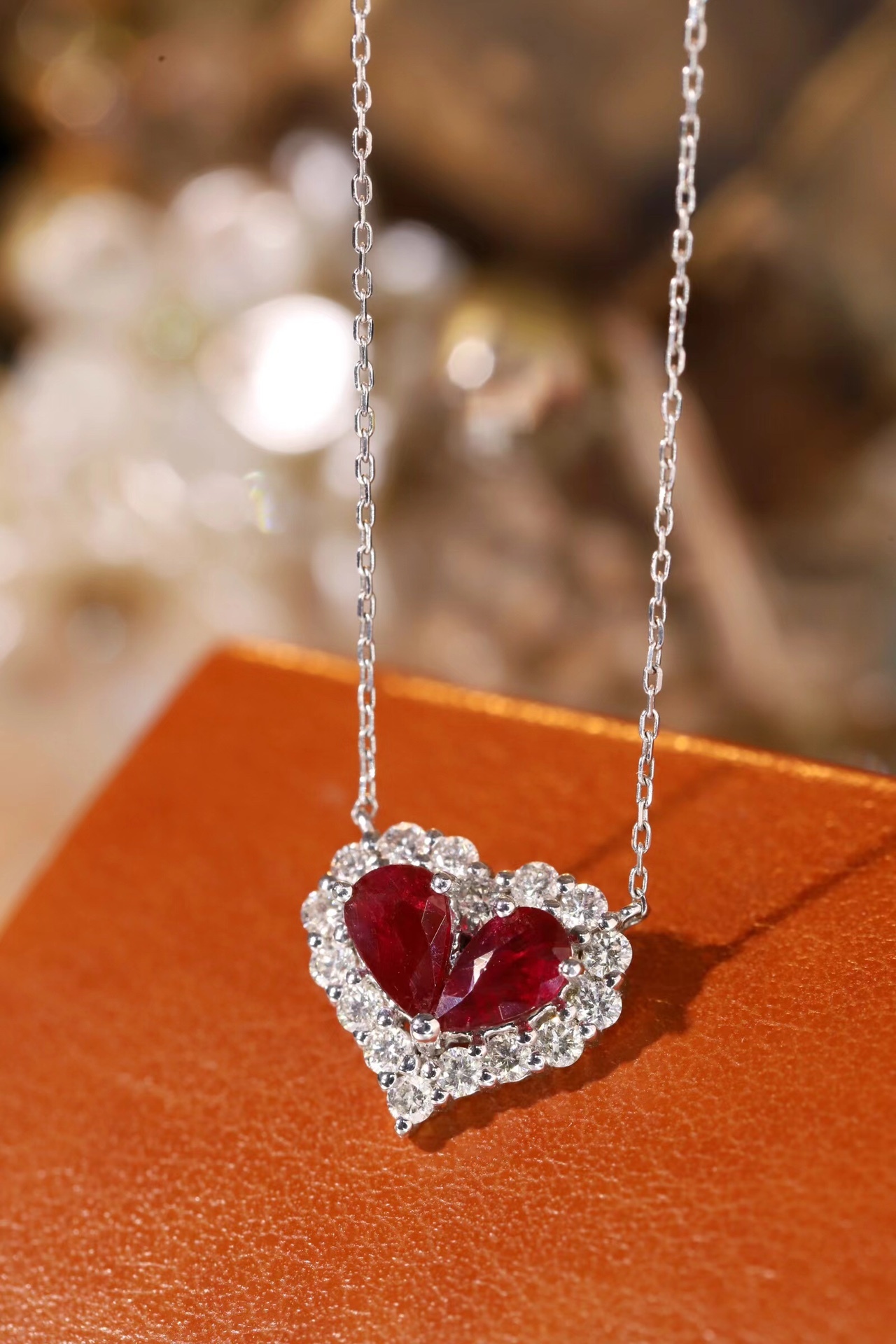 Heart-shaped 18k gold necklace set with a 0.92-carat ruby and a 0.45-carat diamond.