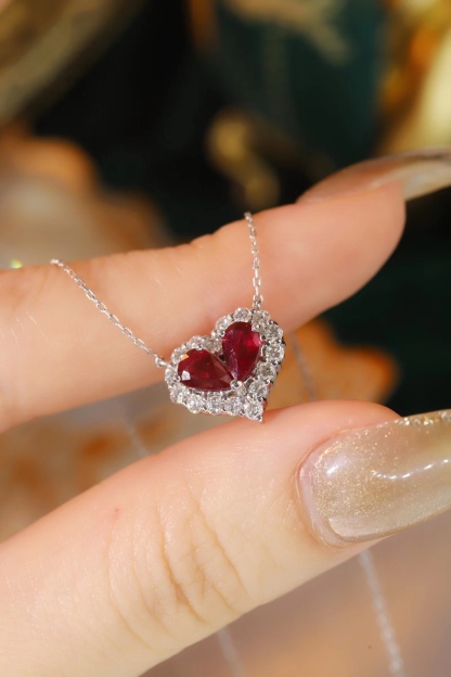 Heart-shaped 18k gold necklace set with a 0.92-carat ruby and a 0.45-carat diamond.