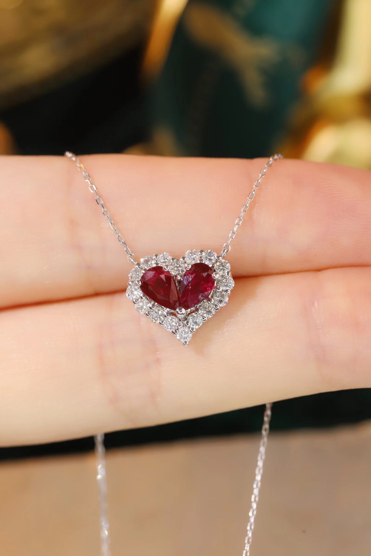 Heart-shaped 18k gold necklace set with a 0.92-carat ruby and a 0.45-carat diamond.