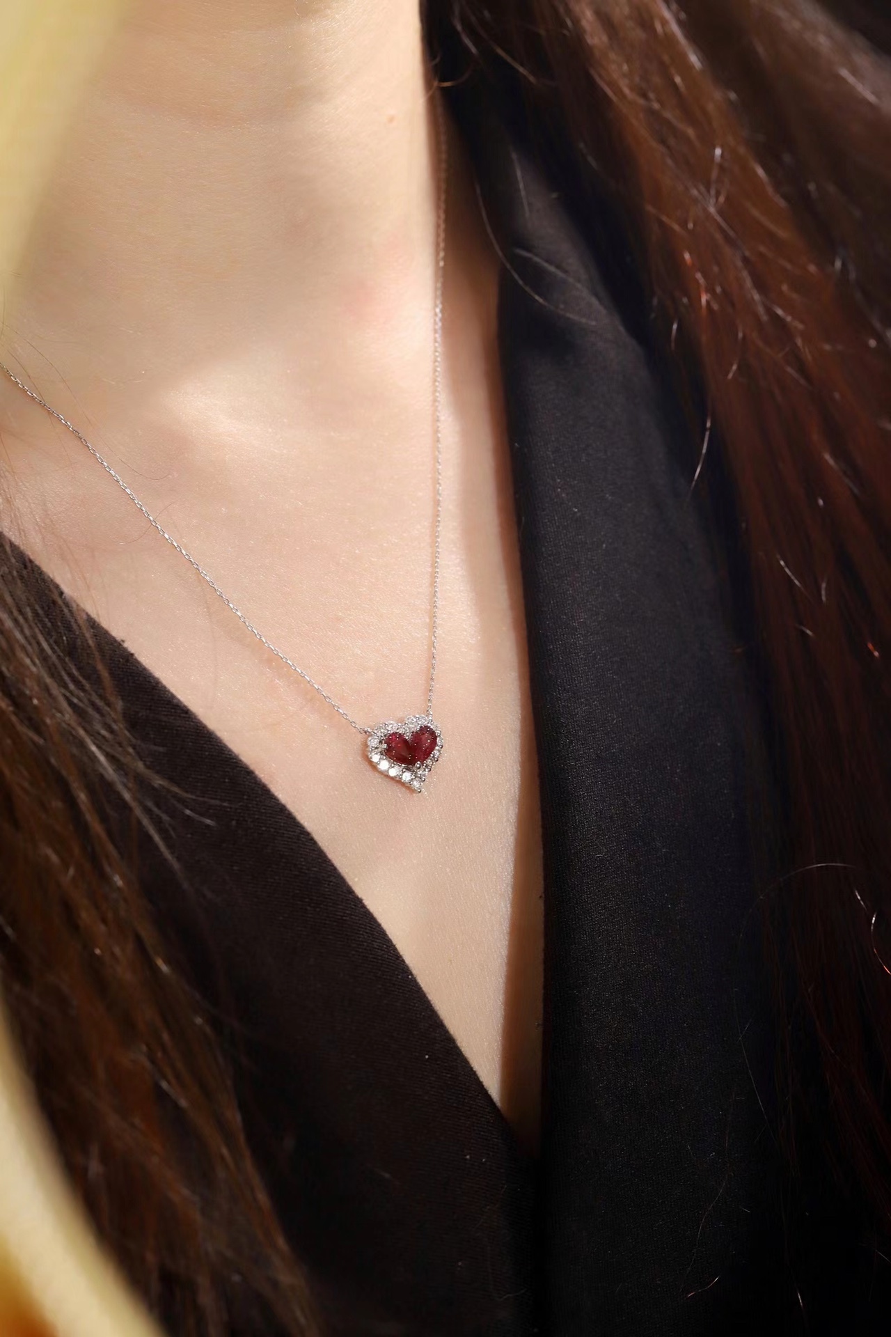 Heart-shaped 18k gold necklace set with a 0.92-carat ruby and a 0.45-carat diamond.