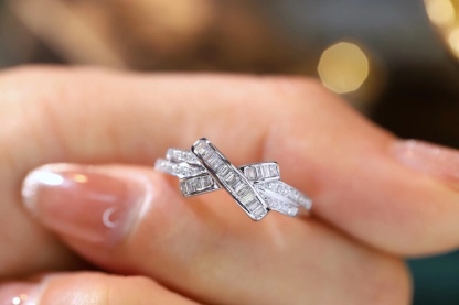 18k gold ring set with a natural diamond; the diamond features a Tapered Baguette cut and weighs 0.20 carats.