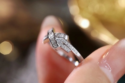 18k gold ring set with a natural diamond; the diamond features a Tapered Baguette cut and weighs 0.20 carats.