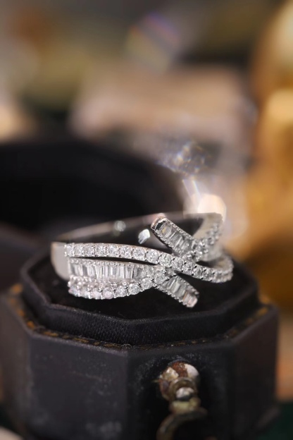 18k gold ring set with a natural diamond; the diamond features a Tapered Baguette cut and weighs 0.60 carats.