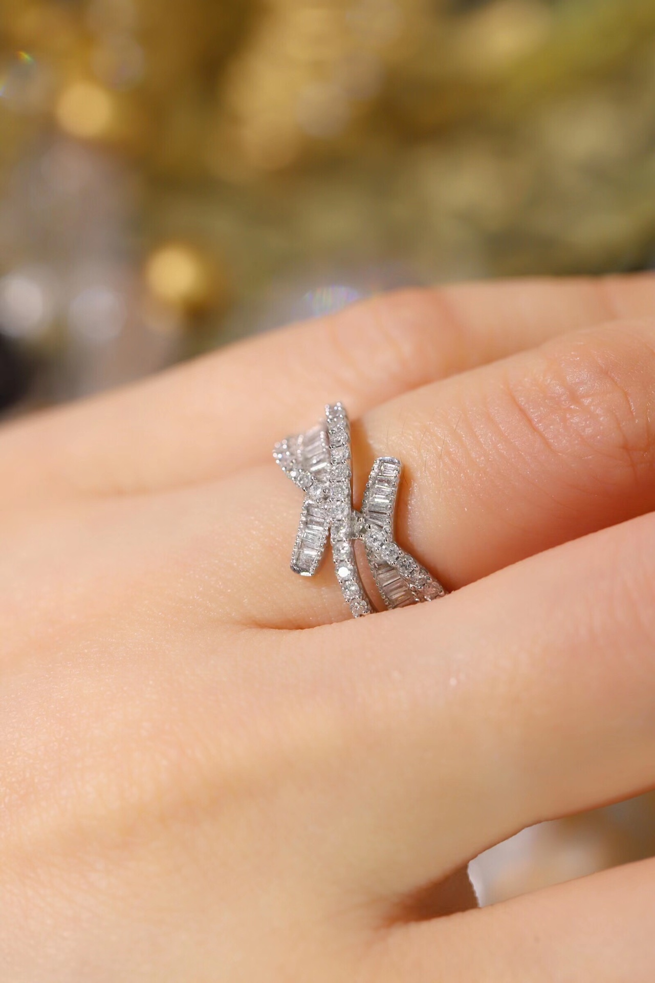 18k gold ring set with a natural diamond; the diamond features a Tapered Baguette cut and weighs 0.60 carats.