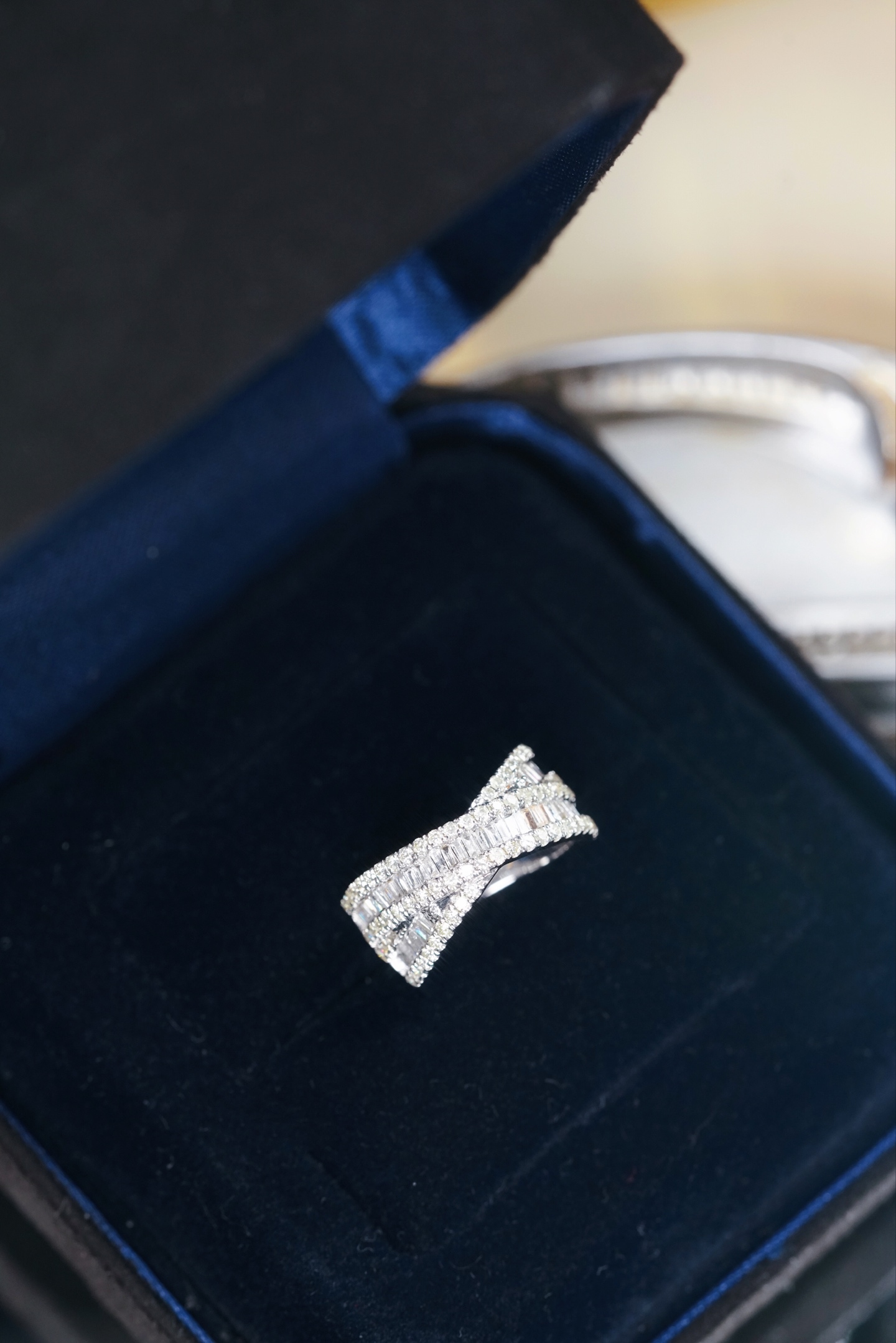 18k gold ring set with a natural diamond; the diamond features a Tapered Baguette cut and weighs 1.00 carats.