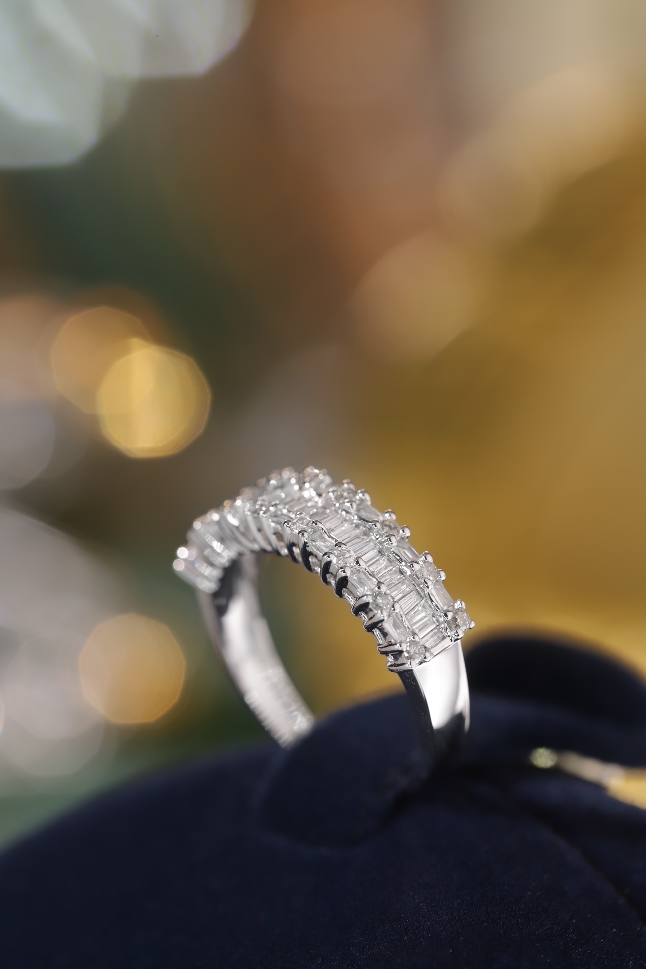 18k gold ring set with a natural diamond; the diamond features a Tapered Baguette cut and weighs 0.55 carats.