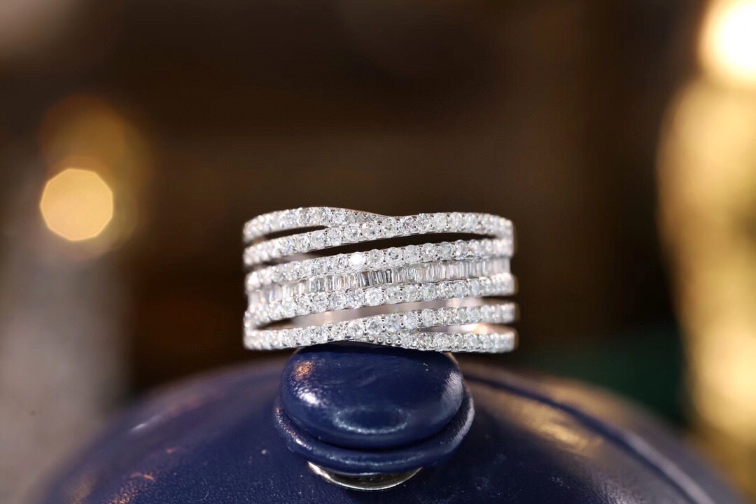 18k gold ring set with a natural diamond; the diamond features a Tapered Baguette cut and weighs 0.68carats.