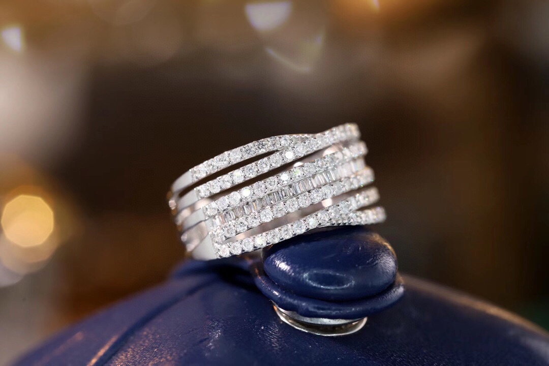 18k gold ring set with a natural diamond; the diamond features a Tapered Baguette cut and weighs 0.68carats.