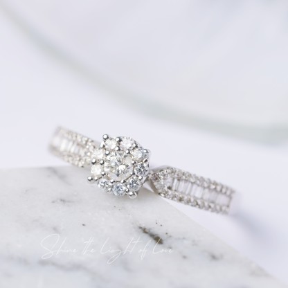 18k gold ring set with a natural diamond; the diamond features a Tapered Baguette cut and weighs 0.47carats.