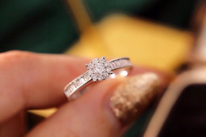 18k gold ring set with a natural diamond; the diamond features a Tapered Baguette cut and weighs 0.40carats.