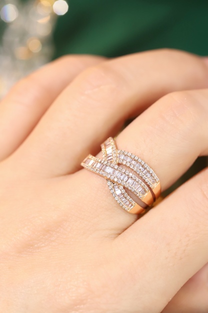 18k gold ring set with a natural diamond; the diamond features a Tapered Baguette cut and weighs 0.75carats.