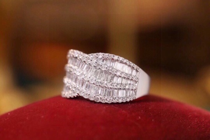 18k gold ring set with a natural diamond; the diamond features a Tapered Baguette cut and weighs 1.10carats.