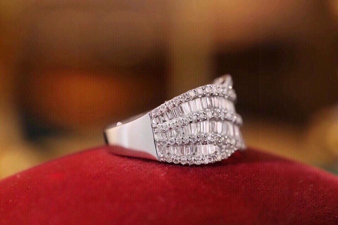 18k gold ring set with a natural diamond; the diamond features a Tapered Baguette cut and weighs 1.10carats.