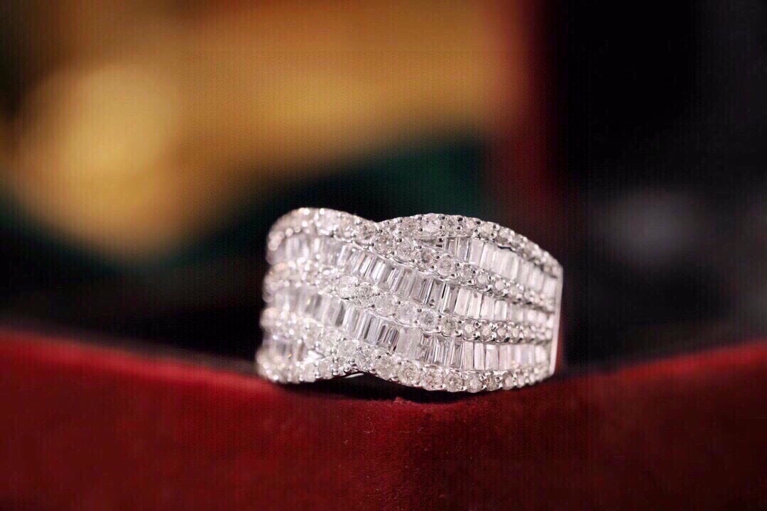 18k gold ring set with a natural diamond; the diamond features a Tapered Baguette cut and weighs 1.10carats.