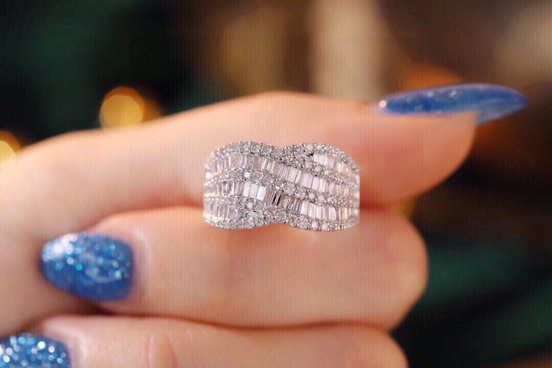 18k gold ring set with a natural diamond; the diamond features a Tapered Baguette cut and weighs 1.10carats.