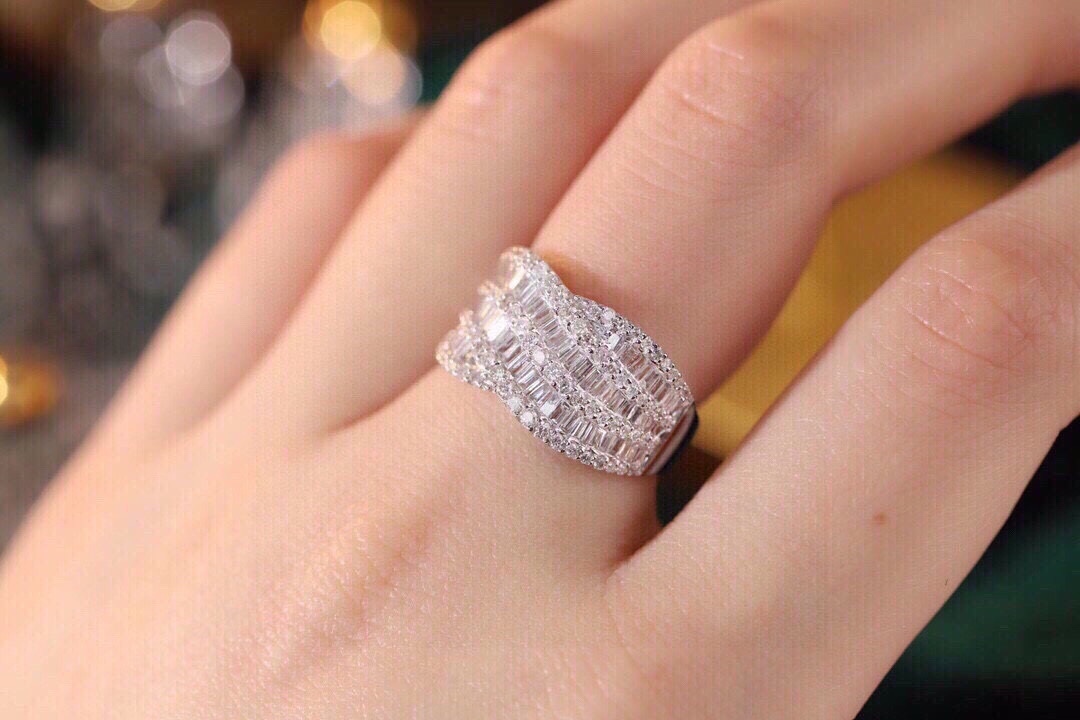 18k gold ring set with a natural diamond; the diamond features a Tapered Baguette cut and weighs 1.10carats.