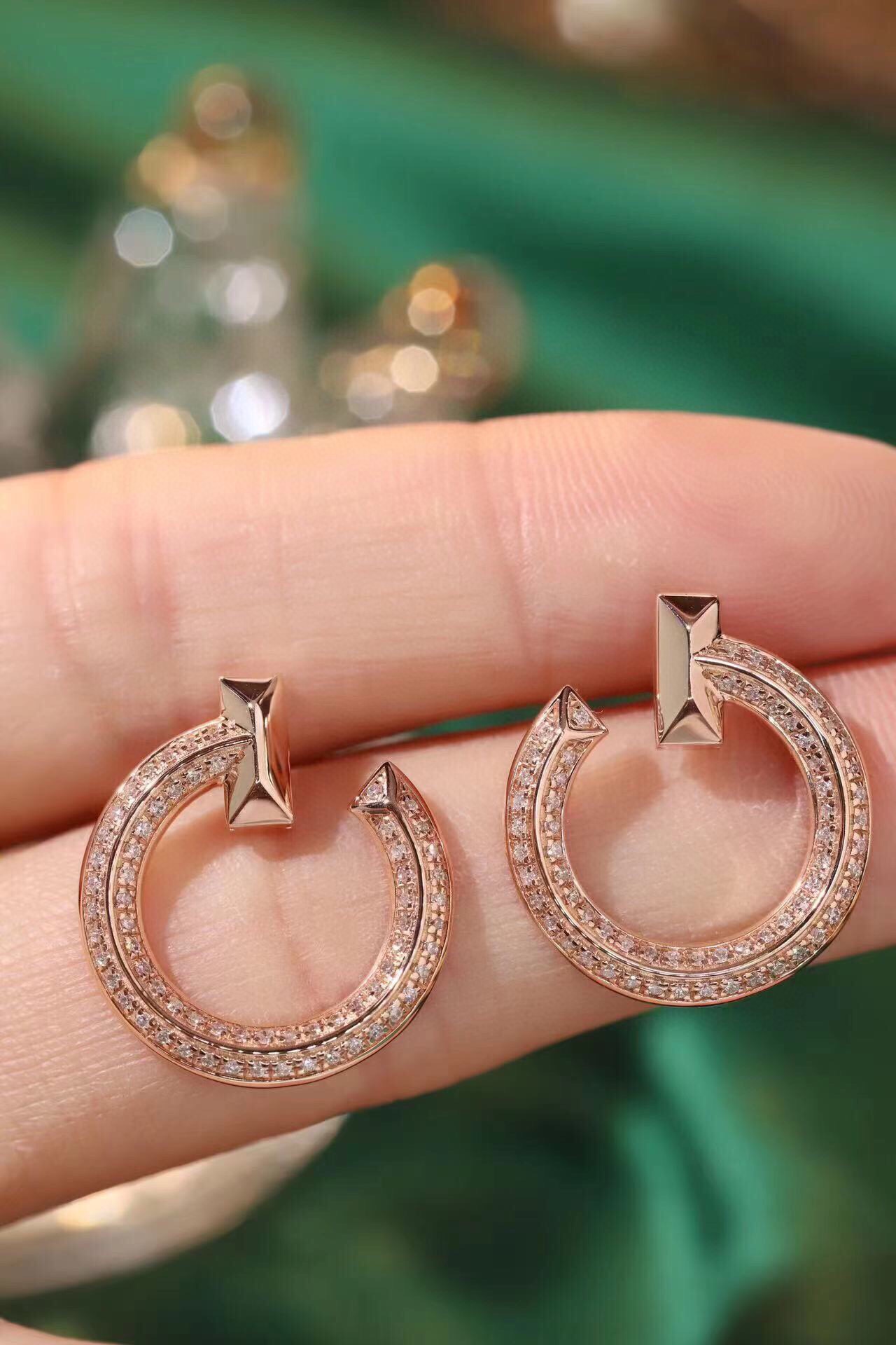 18k gold earrings set with a 0.38ct natural diamond; the earrings have a unique design.