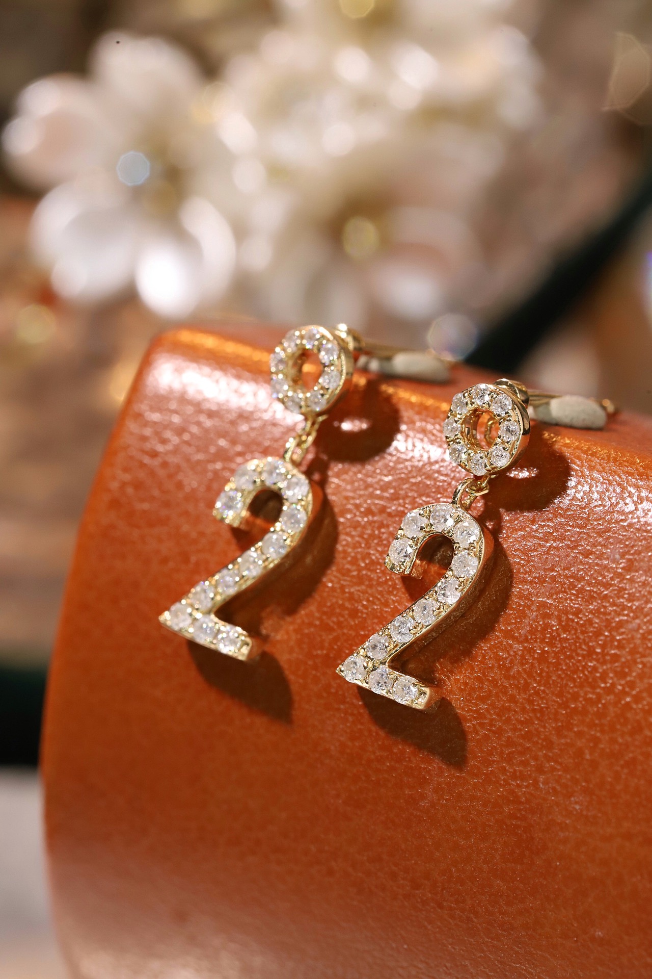 18k gold earring stud set with a 0.36ct natural diamond and the number “2” embossed on it.