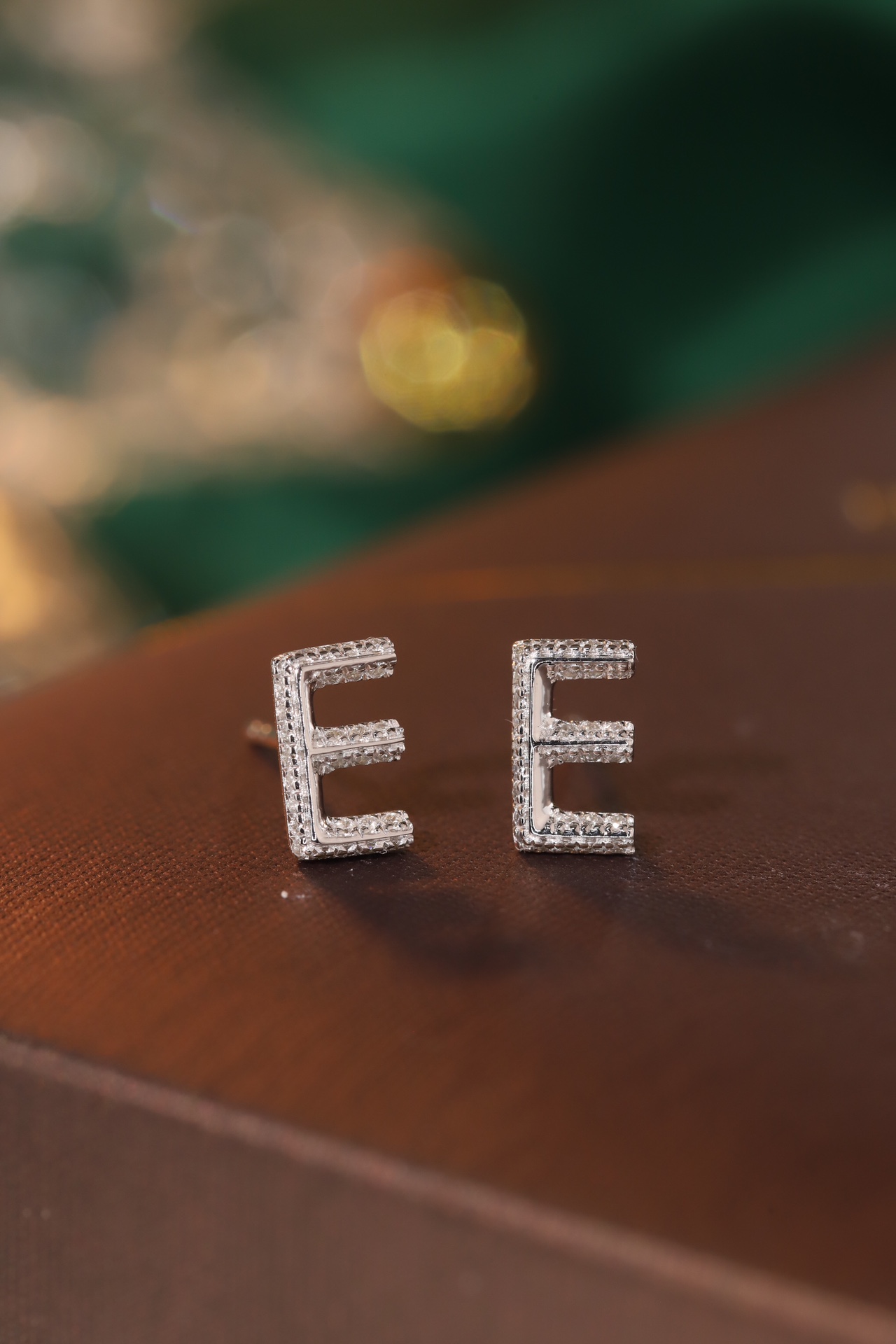 18k gold earring stud with the letter “E” and a 0.10ct natural diamond inlaid.