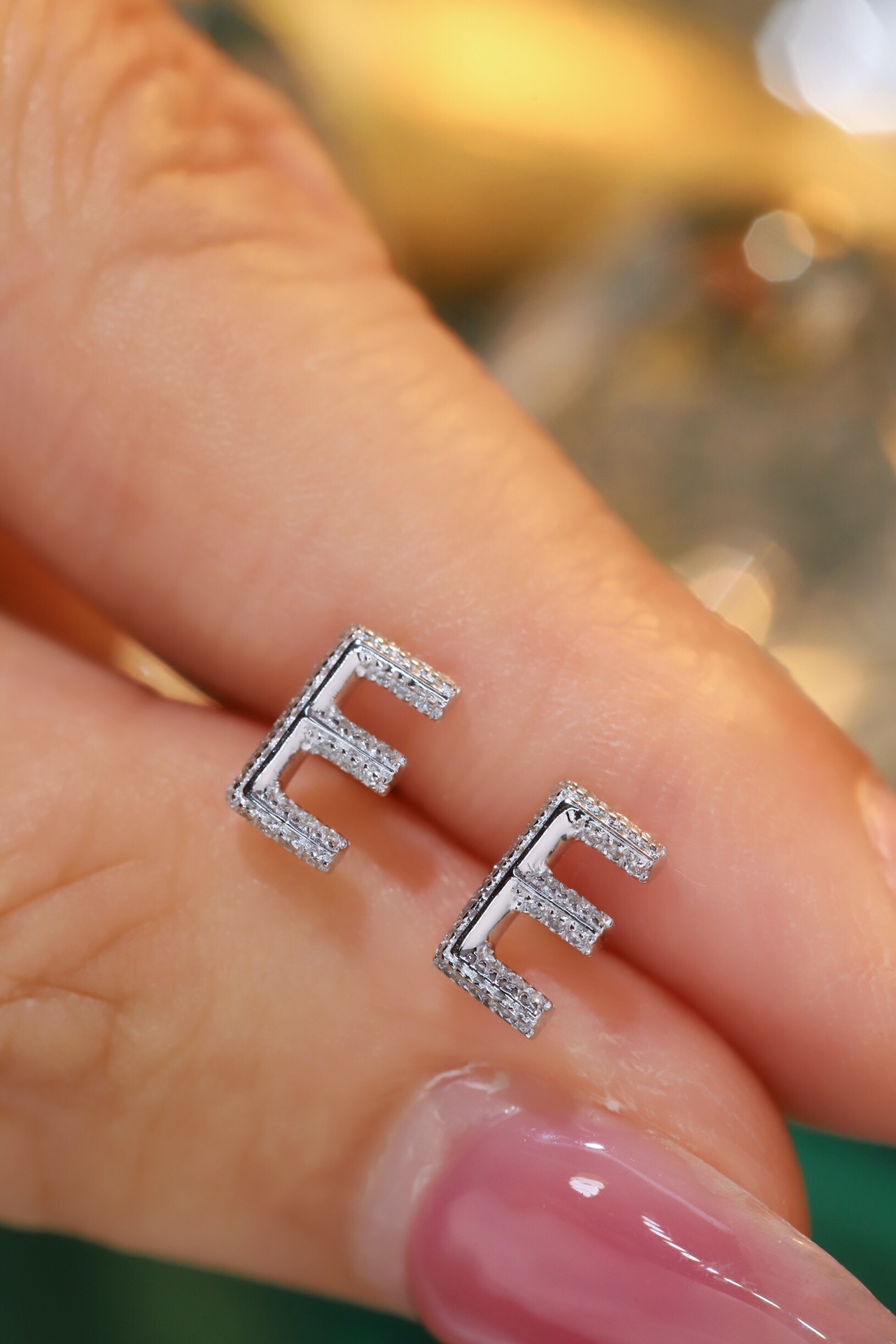 18k gold earring stud with the letter “E” and a 0.10ct natural diamond inlaid.