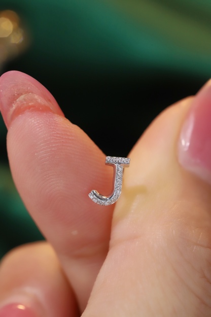 18k gold earring stud with the letter “J” and a 0.08ct natural diamond inlaid.