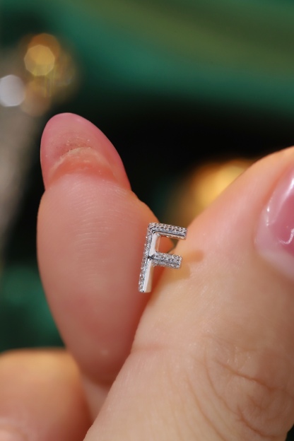 18k gold earring stud with the letter “F” and a 0.06ct natural diamond inlaid.