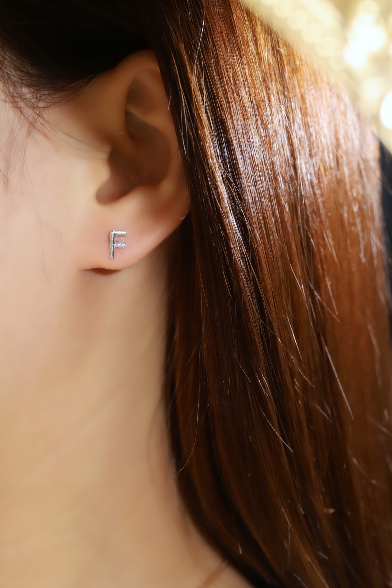 18k gold earring stud with the letter “F” and a 0.06ct natural diamond inlaid.