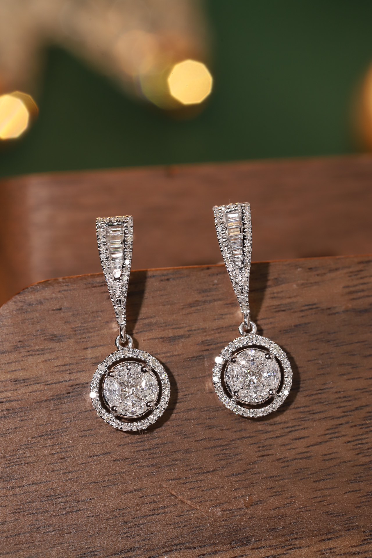 18k earrings set with a 0.60ct natural diamond; featuring a combination of marquise and princess cut diamonds.