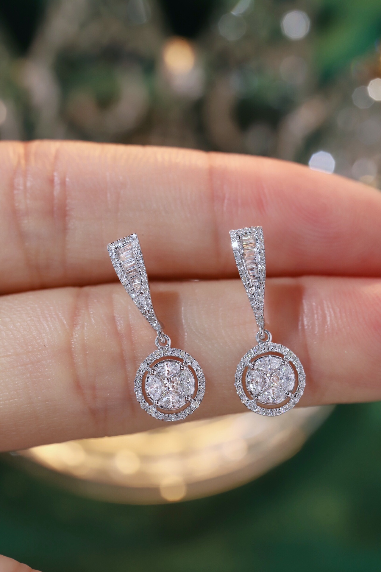 18k earrings set with a 0.60ct natural diamond; featuring a combination of marquise and princess cut diamonds.