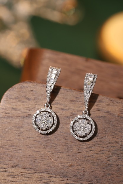 18k earrings set with a 0.60ct natural diamond; featuring a combination of marquise and princess cut diamonds.