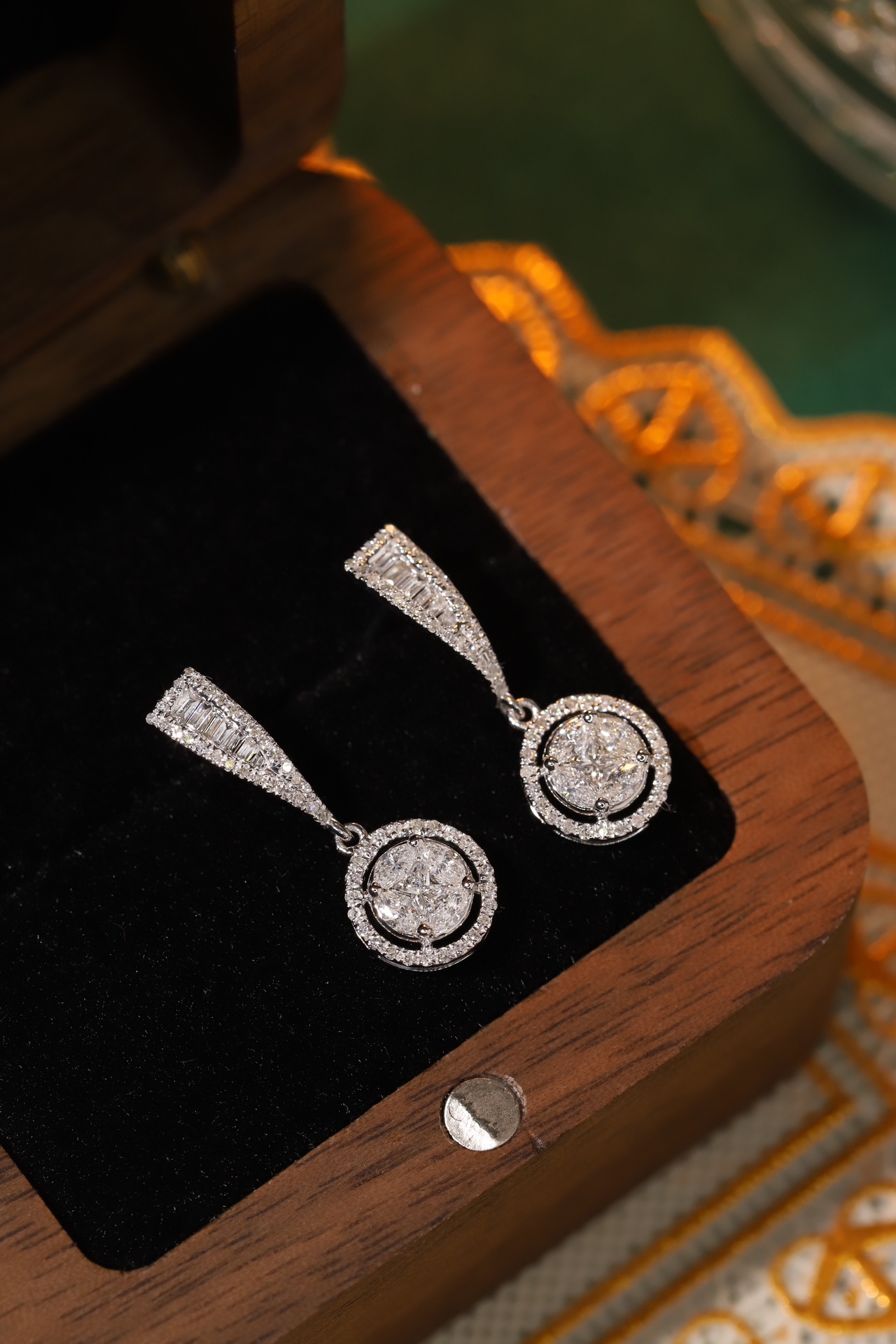 18k earrings set with a 0.60ct natural diamond; featuring a combination of marquise and princess cut diamonds.