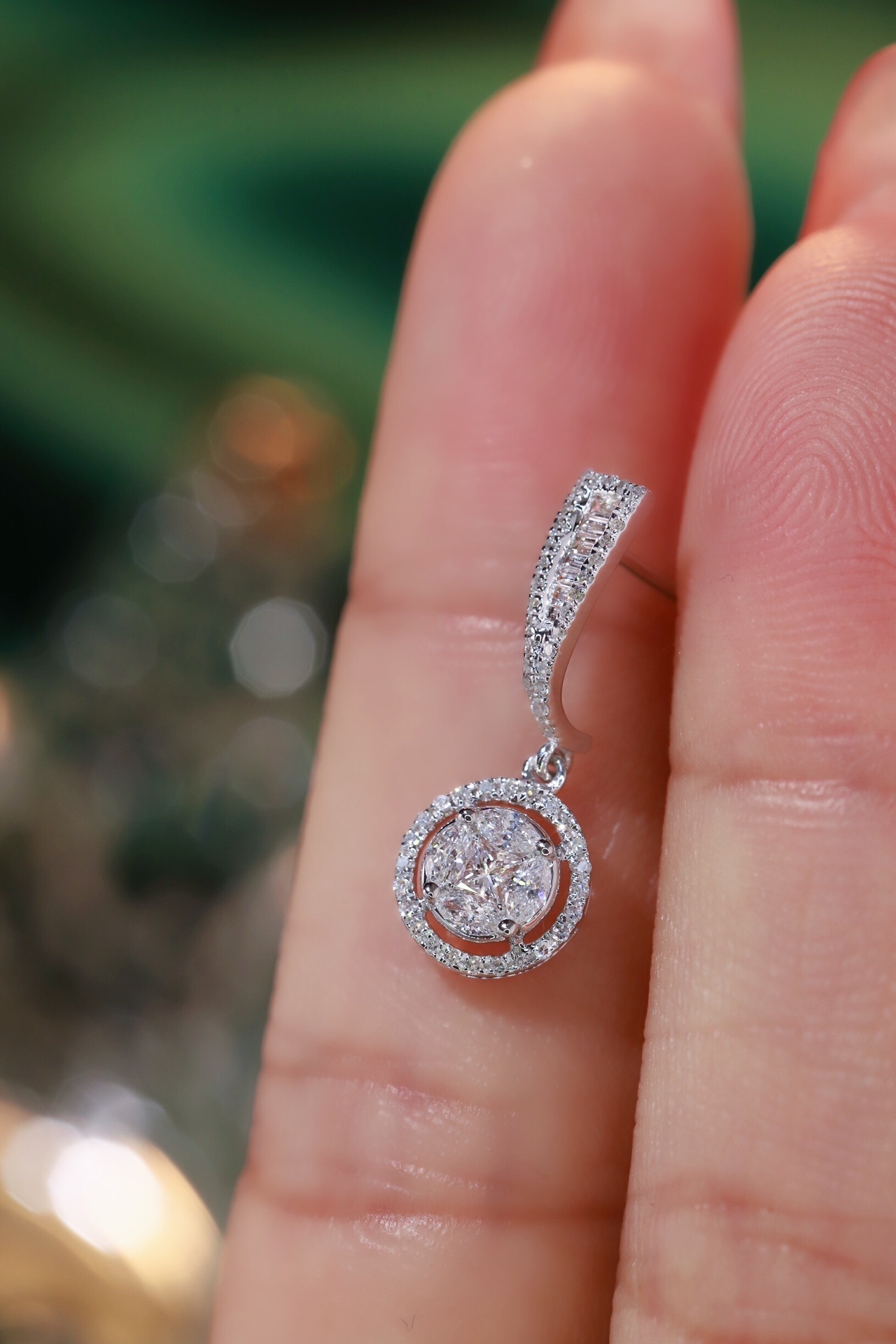 18k earrings set with a 0.60ct natural diamond; featuring a combination of marquise and princess cut diamonds.