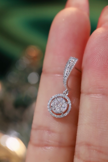 18k earrings set with a 0.60ct natural diamond; featuring a combination of marquise and princess cut diamonds.