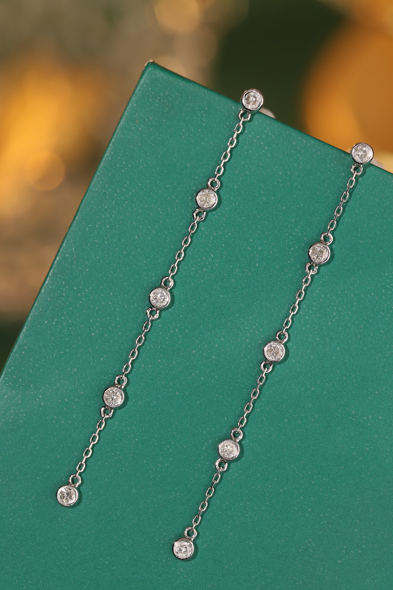 18k gold earrings with bezel setting, featuring a 0.30ct natural diamond.