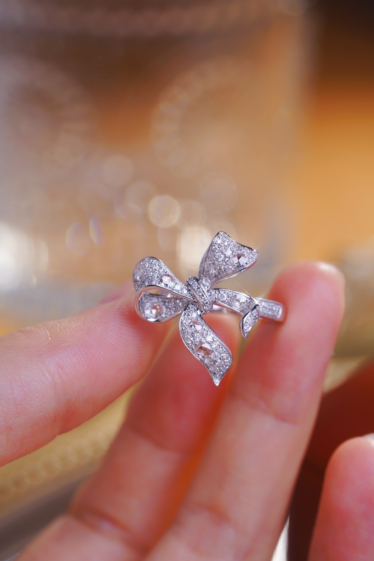 18k gold ring with a bow design, featuring a 0.75ct Rose cut diamond