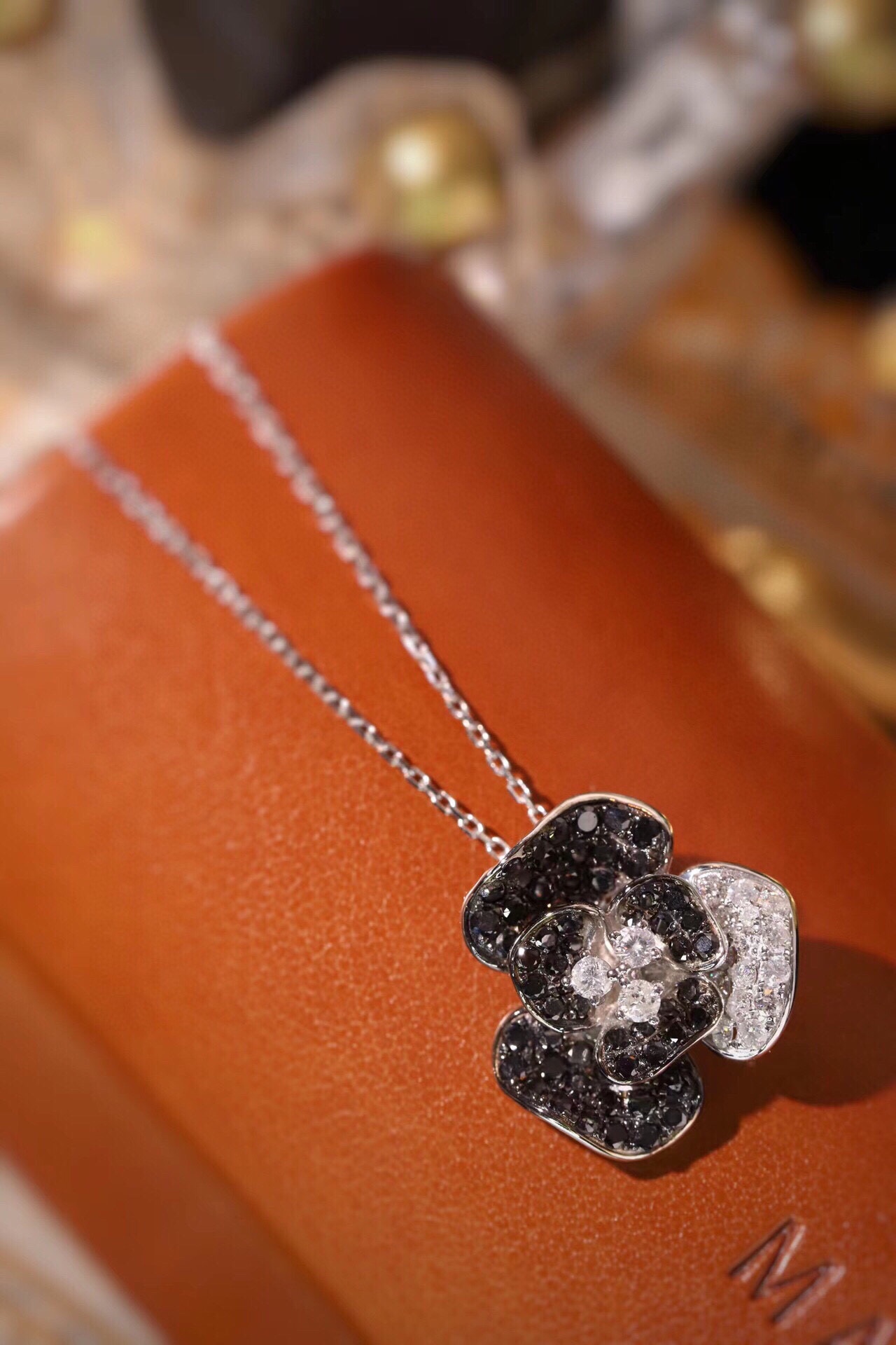 18k Gold Necklace with Flower Design, featuring a combination of black and white diamonds