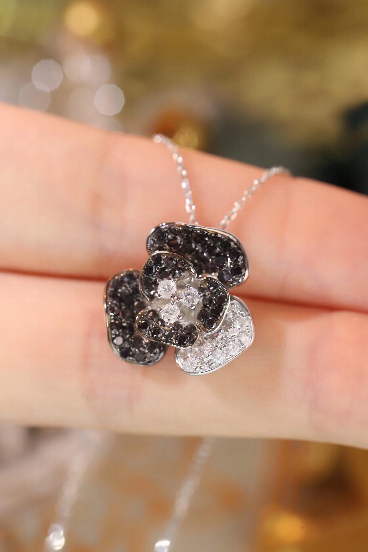 18k Gold Necklace with Flower Design, featuring a combination of black and white diamonds