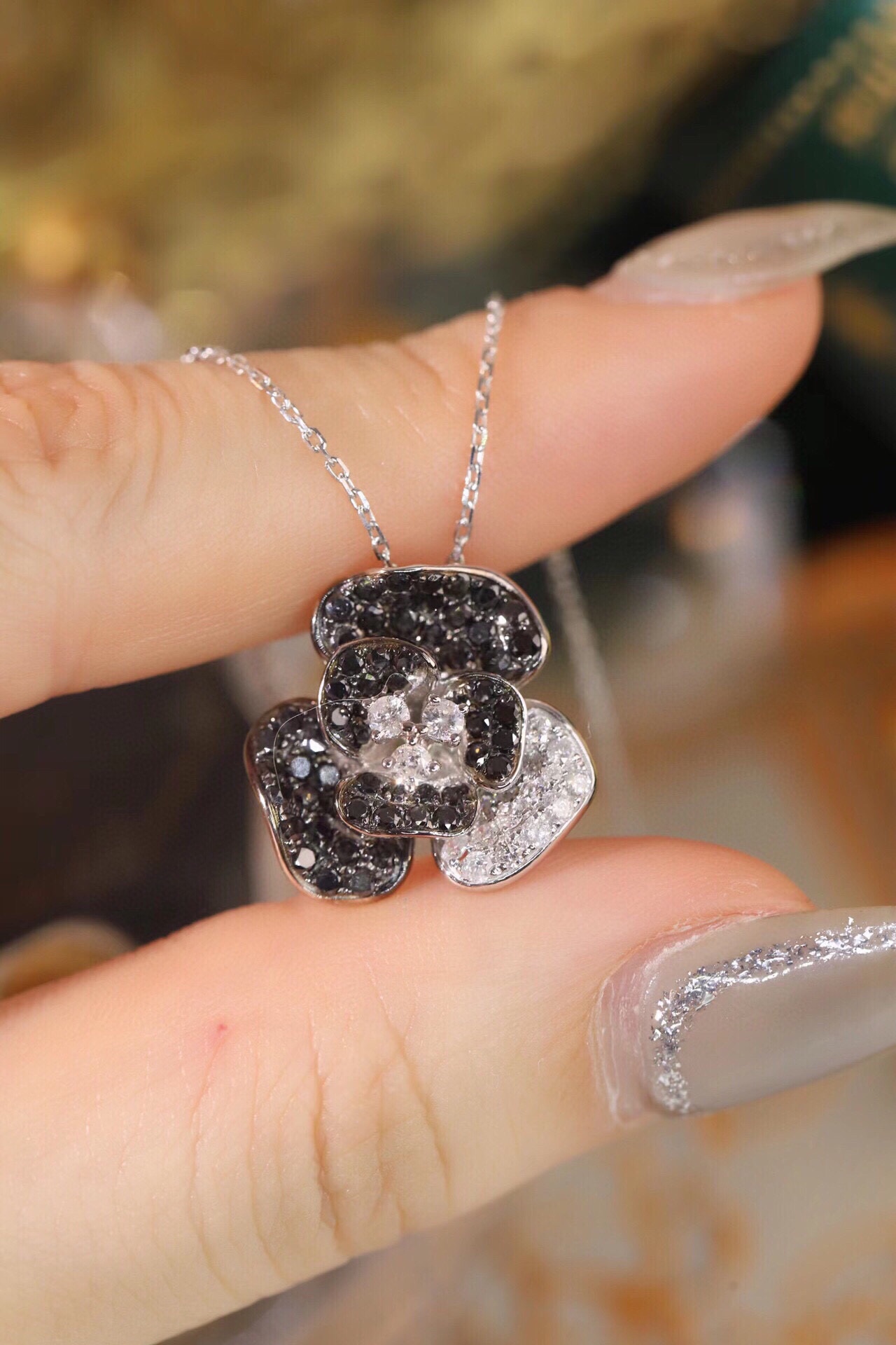 18k Gold Necklace with Flower Design, featuring a combination of black and white diamonds