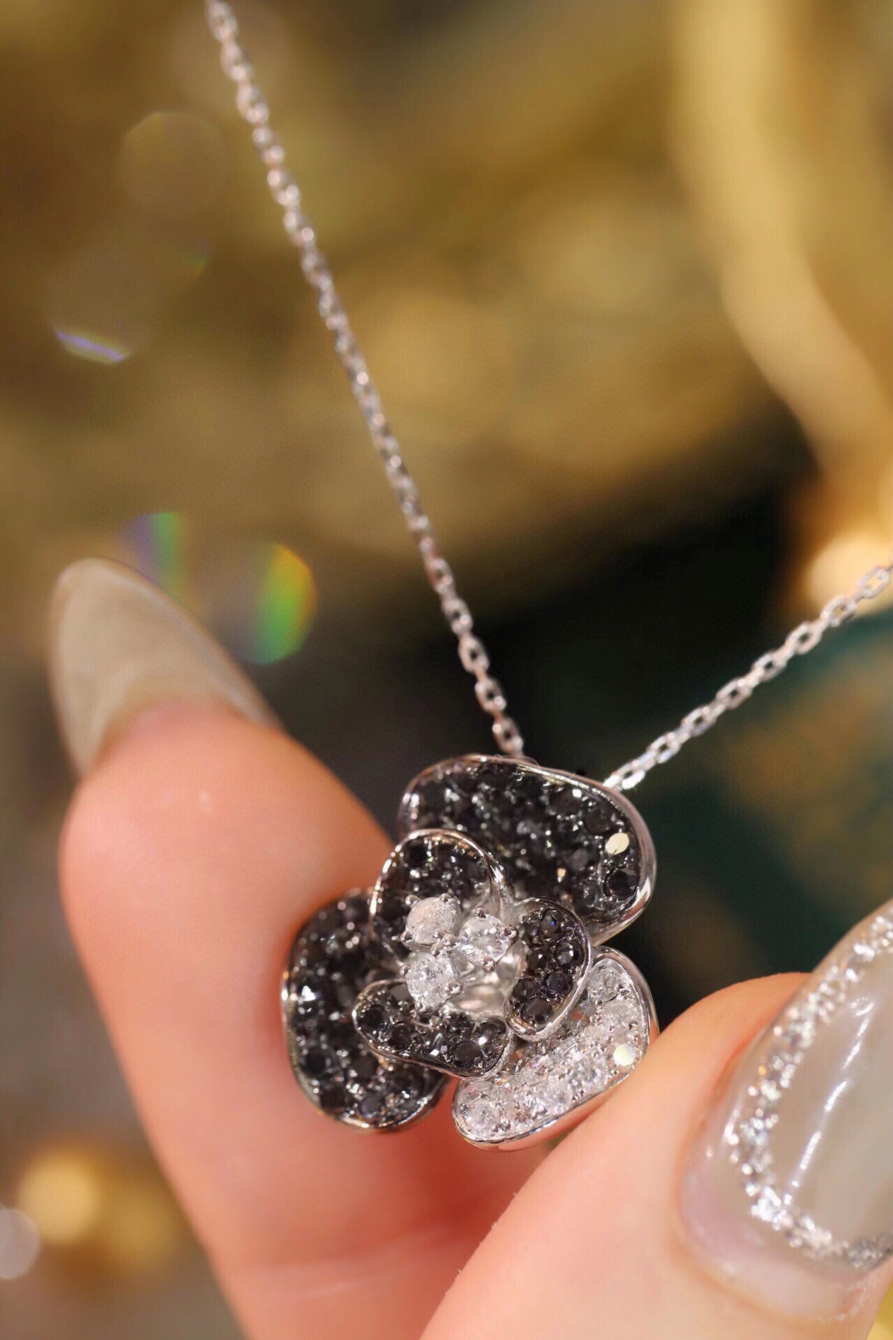 18k Gold Necklace with Flower Design, featuring a combination of black and white diamonds
